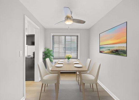 a dining room with a table and chairs and a ceiling fan at Huntley Ridge, Kettering