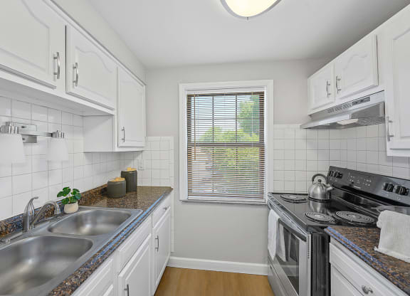 a kitchen with a sink and a stove and a window at Huntley Ridge, Kettering, OH, 45419