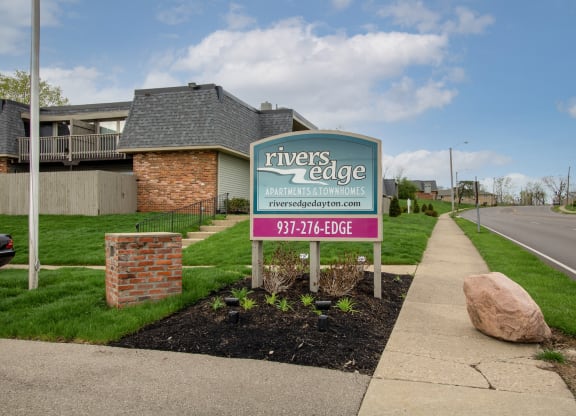 a sign for rivers edge apartments on the side of the street at Rivers Edge Apartments and Townhomes, Ohio