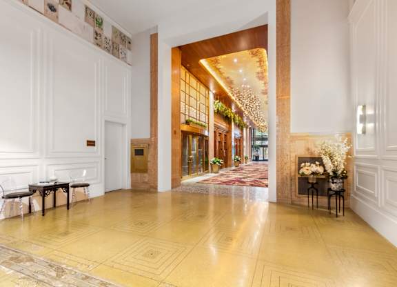 A hallway with a wooden floor and white walls.