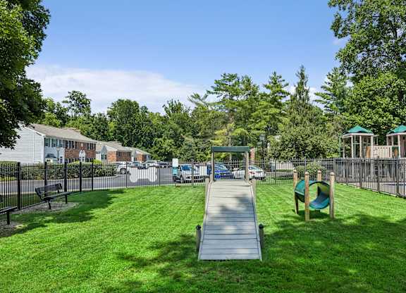 A playground with a slide and a green slide.
