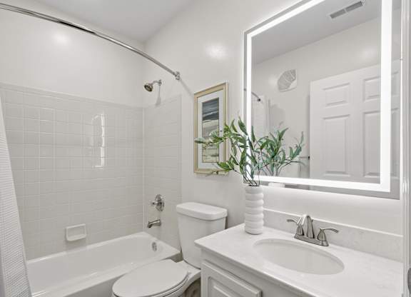 A white bathroom with a toilet, sink, and tub. at Roebling Row, Kentucky, 41011-1720
