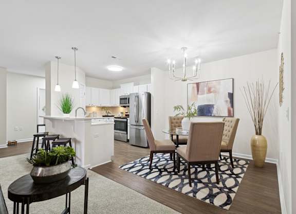 A modern kitchen with a dining table and chairs. at Roebling Row, Covington