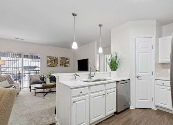 A modern kitchen with white cabinets and a large island. at Roebling Row, Covington, 41011-1720