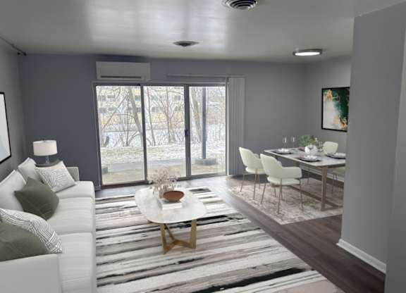 A modern living room with a white sofa and a coffee table.