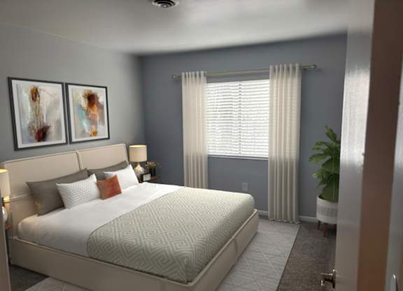 A bedroom with a large bed and two framed pictures on the wall.