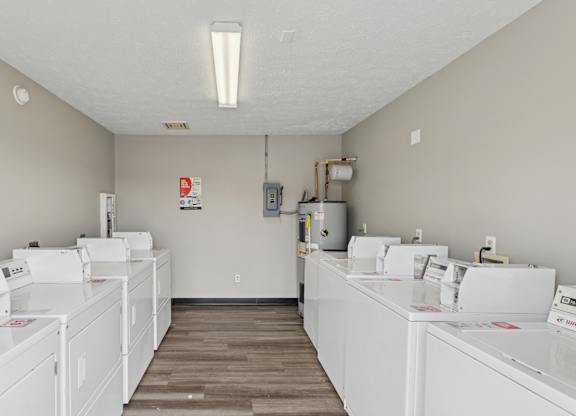 A laundromat with rows of washers and dryers.
