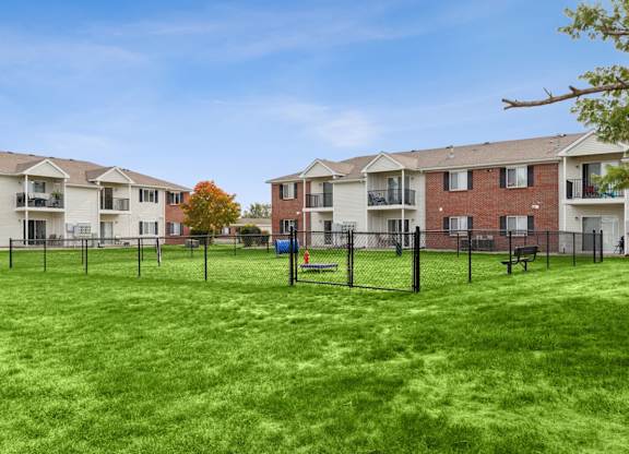 A grassy area in front of apartment buildings.