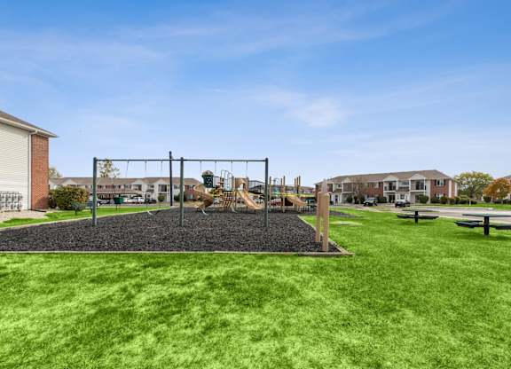 A playground with a swing set and a slide.