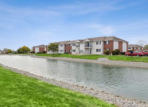 A row of houses with a body of water in front.