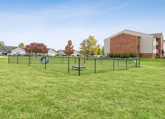 A playground with a swing set and a slide in a grassy area.