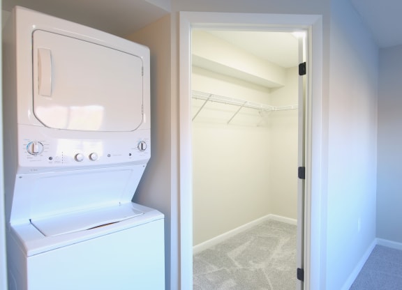a laundry room with a washer and dryer and a closet
