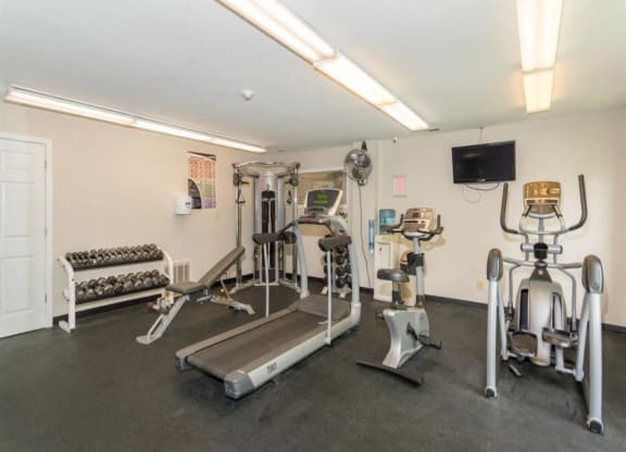 the gym is equipped with cardio equipment and weights at Quail Run Apartments, Columbus, IN