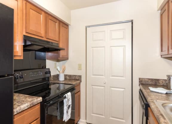 Kitchen area with wooden cabinets at Quail Run, Indiana, 47201