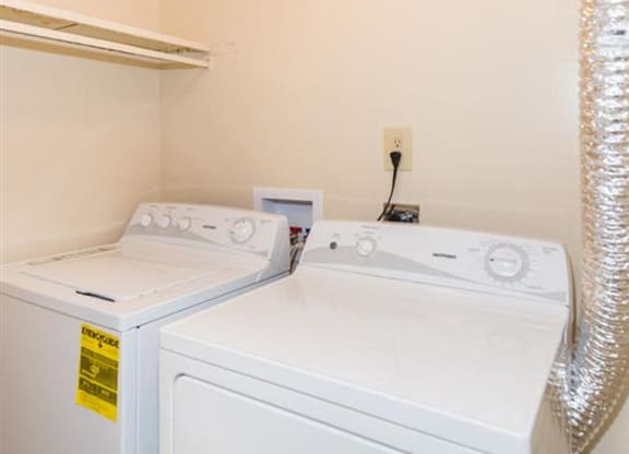 a washer and dryer in a laundry room with a ceiling light at Quail Run Apartments, Columbus, IN, 47201