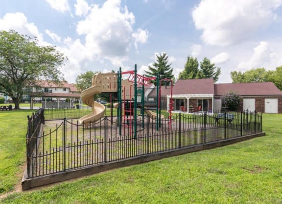 a playground with a slide at a park at Quail Run Apartments, Columbus, IN, 47201