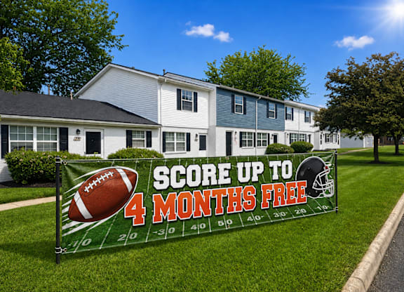 A sign in front of a building advertises a promotion to score up to 4 months free.