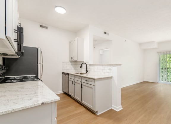 a kitchen with a counter top and a refrigerator