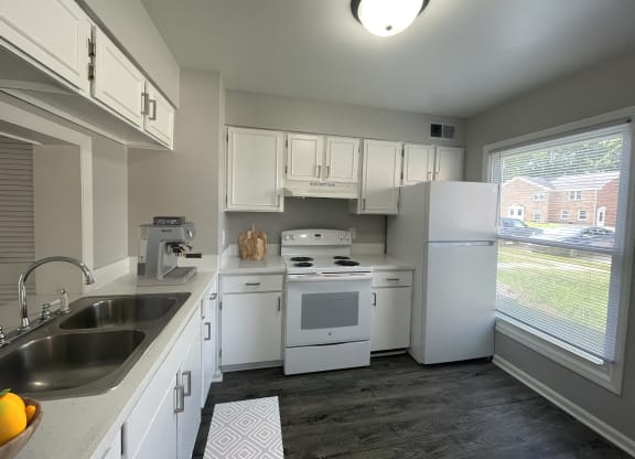 a kitchen with white appliances and white cabinets