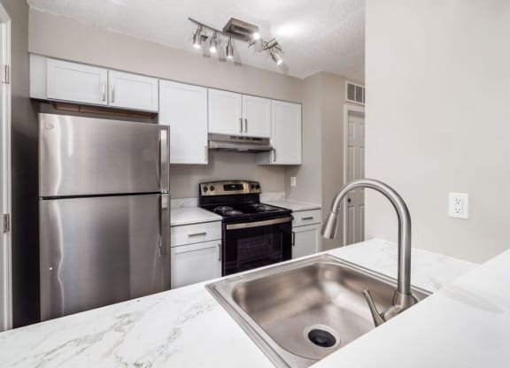 a kitchen with stainless steel appliances and a sink at The Berryessa Apartments, Ohio
