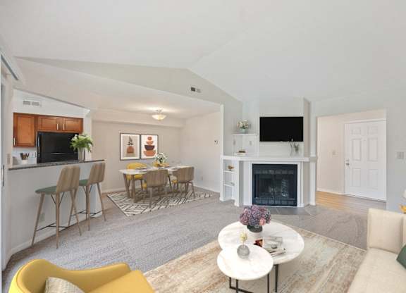 a living room with a fireplace and a table with chairs at Normandy Club Apartments, Centerville