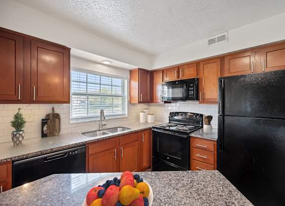 a kitchen with black appliances and granite counter tops at Normandy Club Apartments, Centerville, 45459