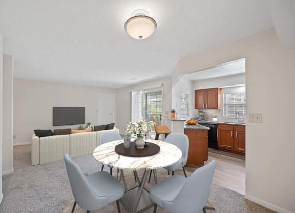 a living room and dining room with a table and chairs at Normandy Club Apartments, Centerville, OH, 45459