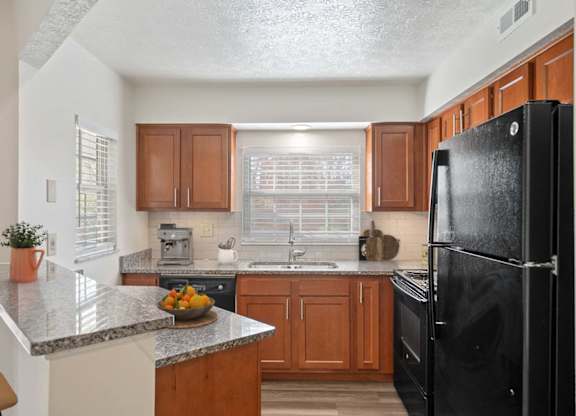 a kitchen with black appliances and granite counter tops at Normandy Club Apartments, Ohio, 45459