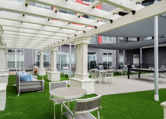 a patio with chairs and tables and a