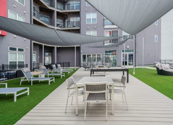 a rendering of a patio with tables and chairs