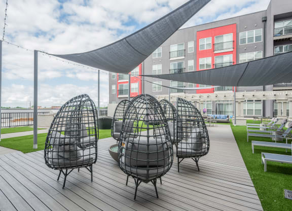 a group of chairs sitting on top of a wooden deck