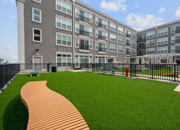 a large green lawn in front of an apartment building