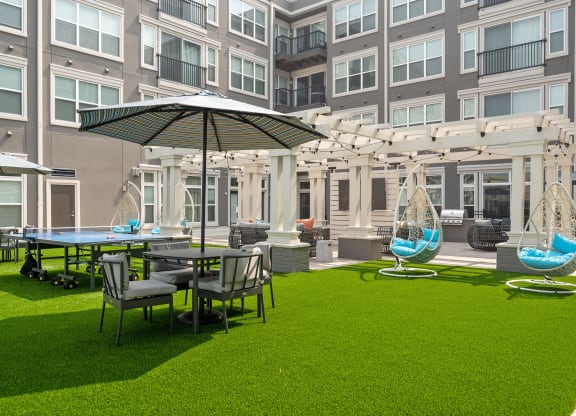 a courtyard with tables and chairs and umbrellas