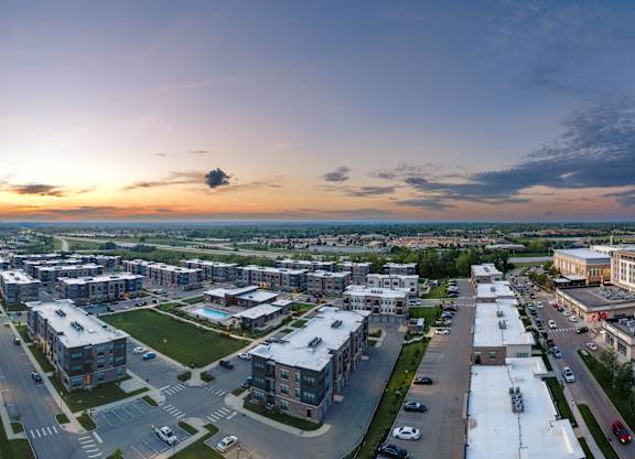 A sunset view of a cityscape with buildings and roads.