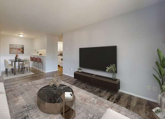 A living room with a white couch and a black television.