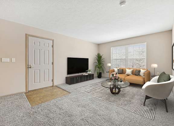 A living room with a grey carpet and a white door.