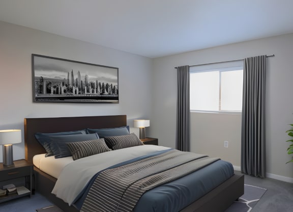 a bedroom with a bed with blue and white sheets and a black and white picture