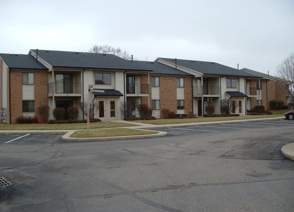 an empty street in front of an apartment building