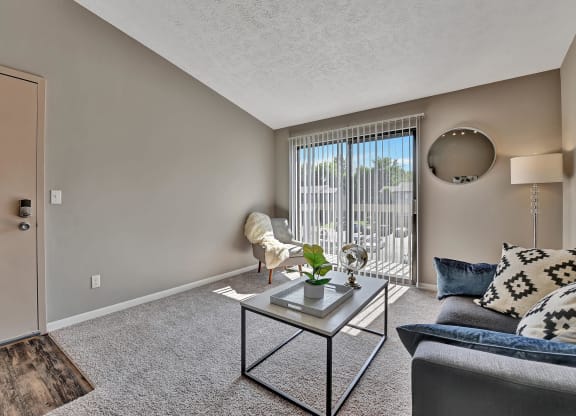 Living room with couch and table at The Reserve at Grand Valley, Milford