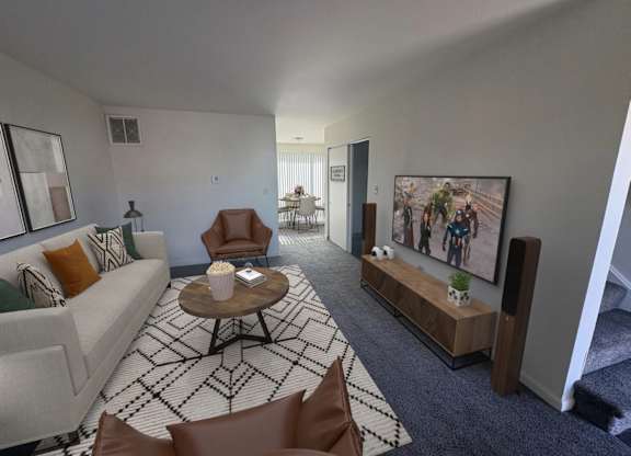 A living room with a couch, chairs, and a coffee table.