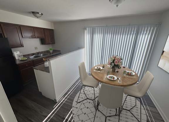 A kitchen with a dining table set for four.
