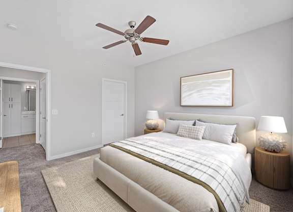 A bedroom with a large bed and a ceiling fan. at Monmouth Row Apartments, Newport, KY
