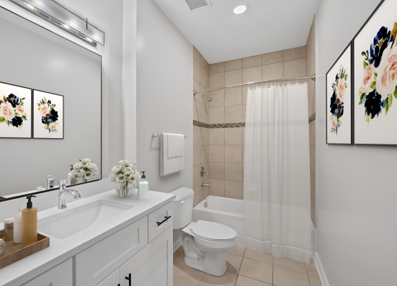 a bathroom with a sink toilet and a shower at Monmouth Row Apartments, Newport, KY