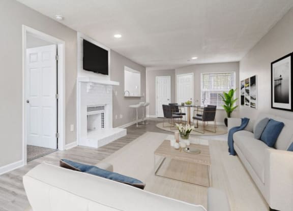 a living room and dining room with a fireplace and a tv at The Berryessa Apartments, Columbus, OH, 98104