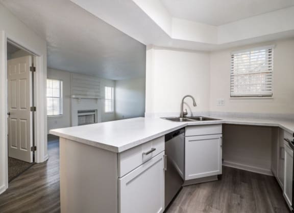 the kitchen of a new home with white cabinets and a white counter top at The Berryessa Apartments, Columbus, OH, 98104