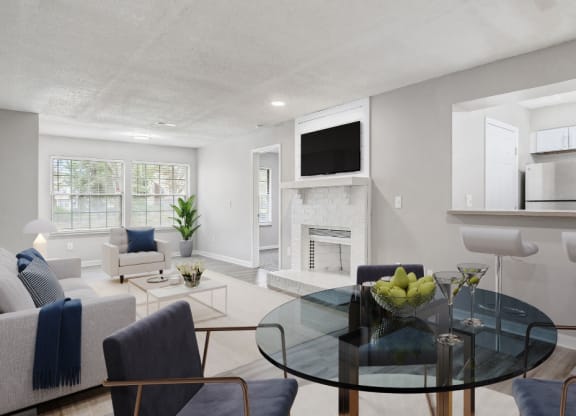 a living room with a glass table and a fireplace at The Berryessa Apartments, Columbus, 98104