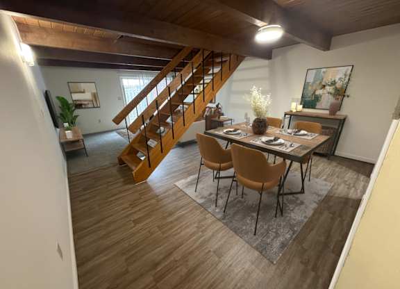 A dining room with a wooden table and chairs.