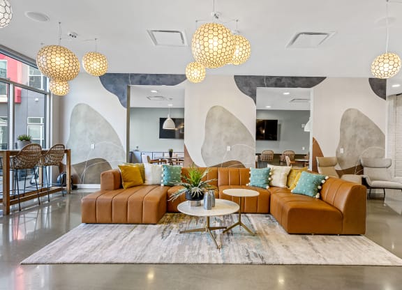 a living room with couches and chairs and a rug