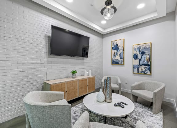 a living room with a table and chairs and a television