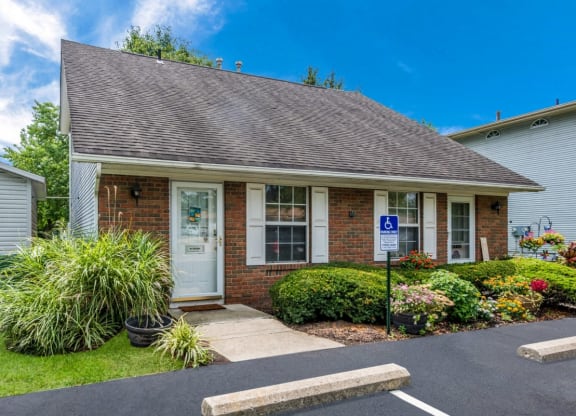 the front of a brick house with a porch and a driveway at Parkside at Maple Canyon Apartments, Columbus, Ohio